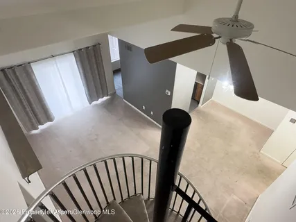 a view of stairs and hall with wooden floor