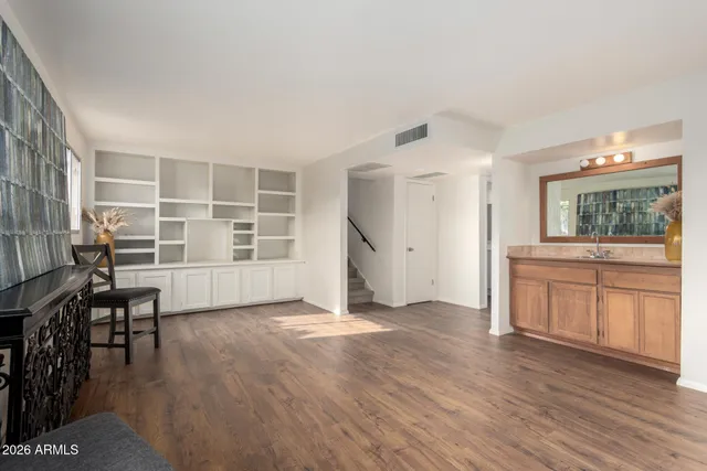 a view of a kitchen with furniture and wooden floor