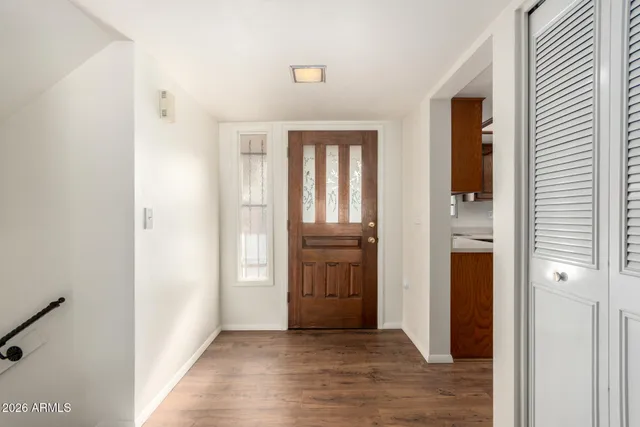 an empty room with windows and cabinet