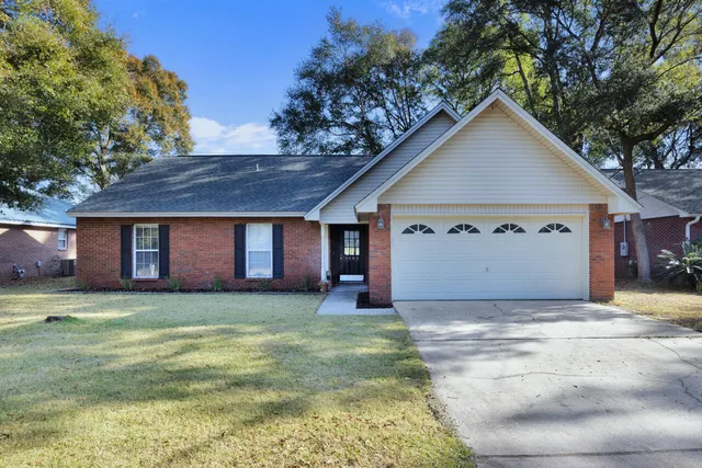 a view of a house with a yard and garage