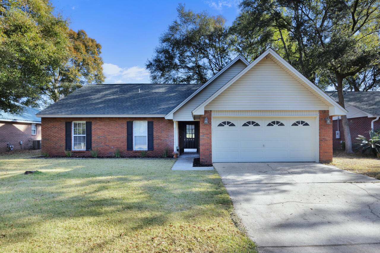 a view of a house with a yard and garage