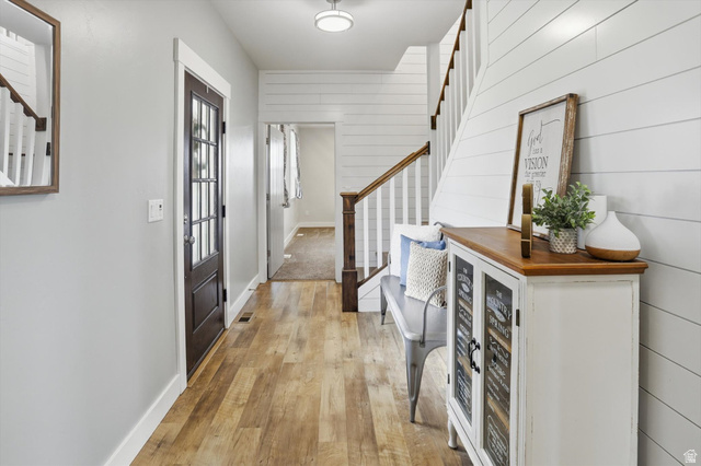 1009 High Creek Road Cove, UT 84320 - Photo 11 of 79 Foyer entrance featuring stairs, light wood-style floors, and wooden walls