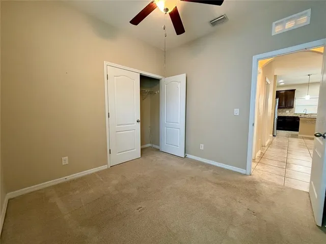a view of a livingroom with a ceiling fan and window