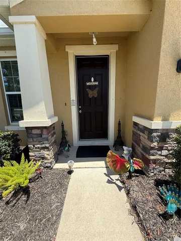 a front view of a house with a yard and trees