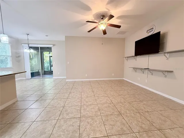a view of an empty room with a fireplace and a flat screen tv