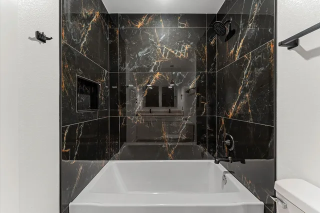 a bathroom with a bathtub and a shower