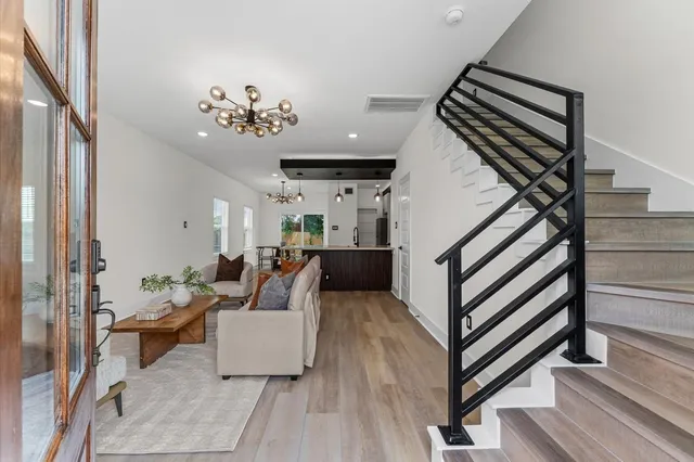 a living room with furniture and wooden floor