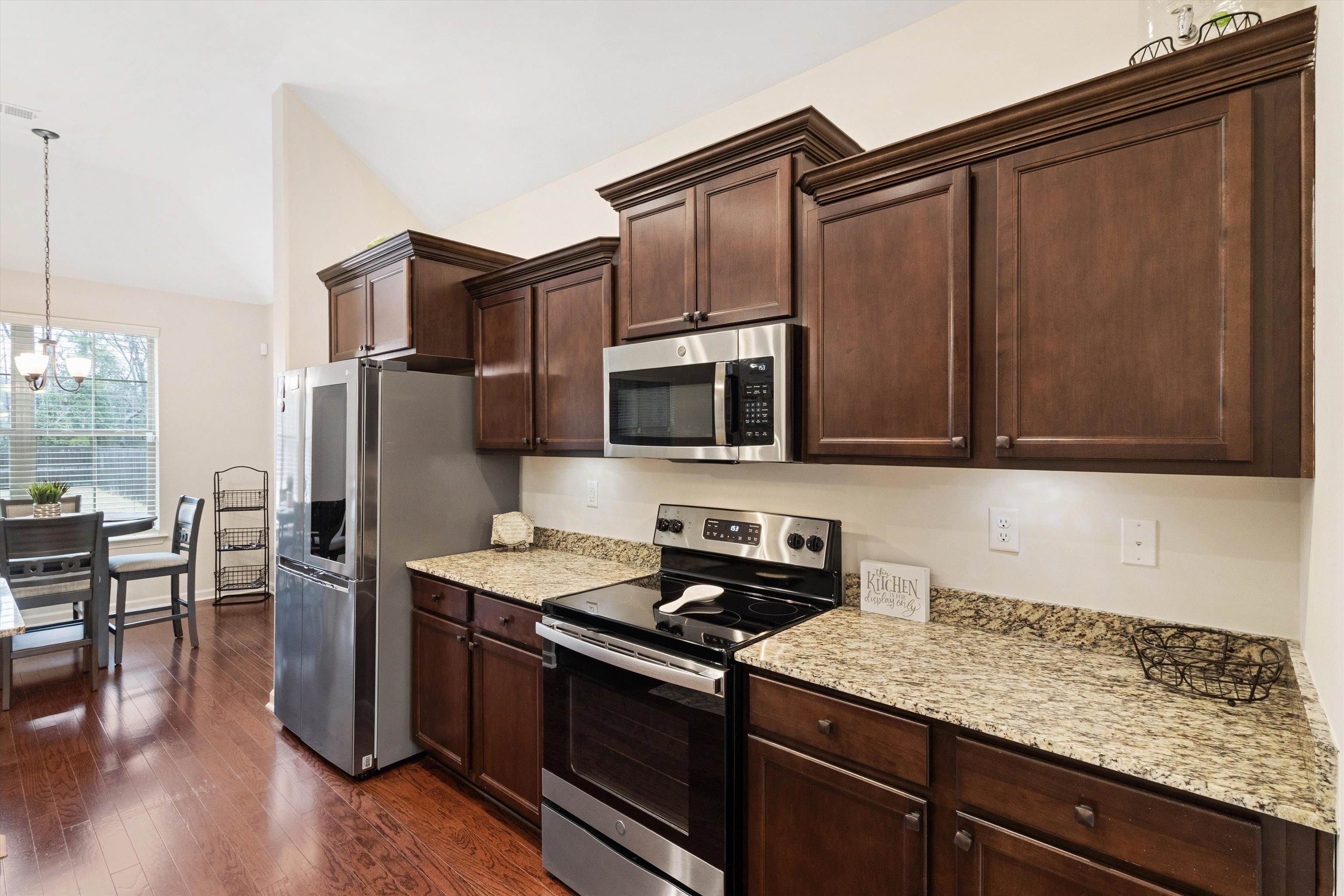 5504 Stonecrest Drive Olive Branch, MS 38654 - Photo 19 of 19 a kitchen with stainless steel appliances granite countertop a refrigerator stove and microwave