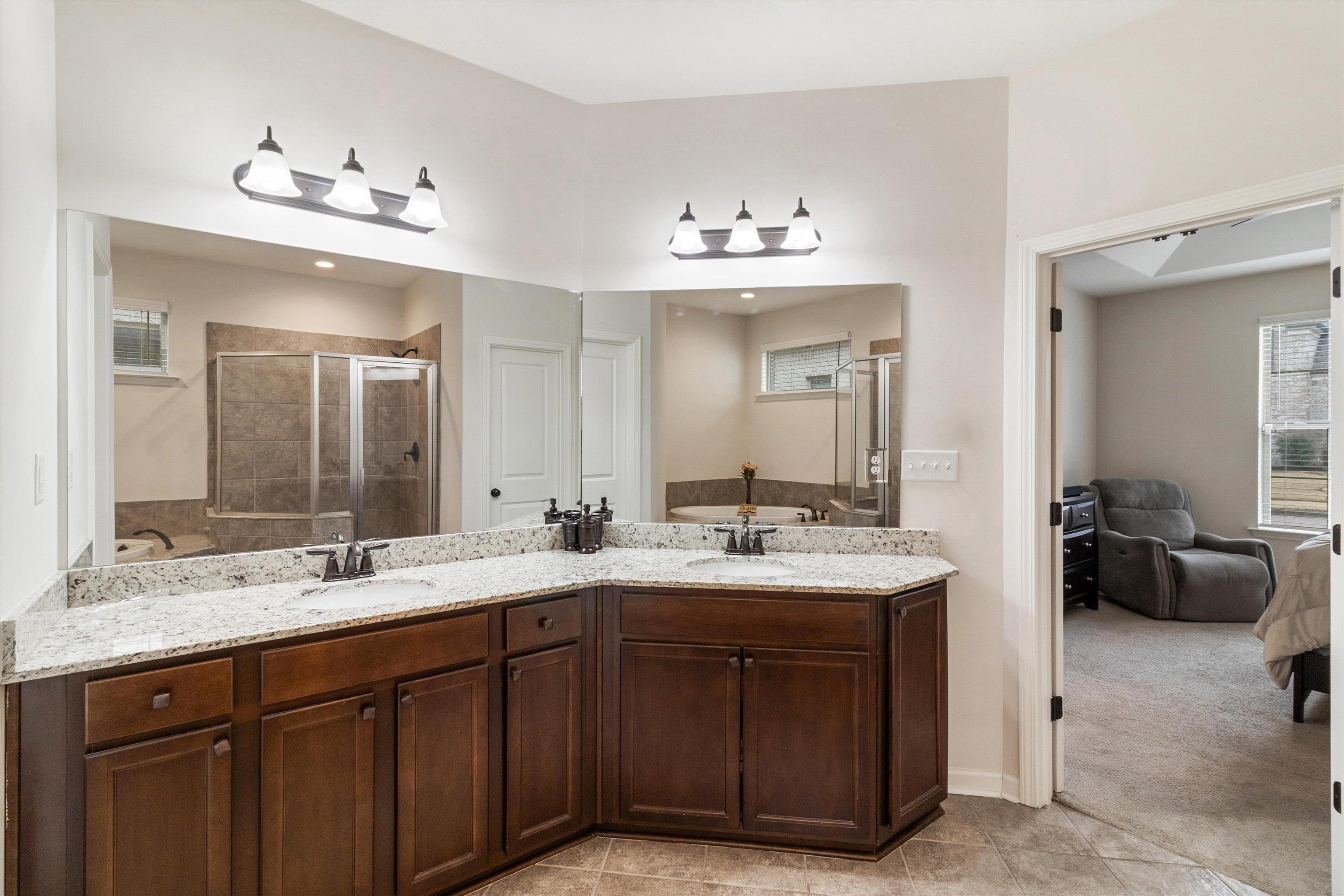 5504 Stonecrest Drive Olive Branch, MS 38654 - Photo 8 of 19 a bathroom with a double vanity sink and a mirror