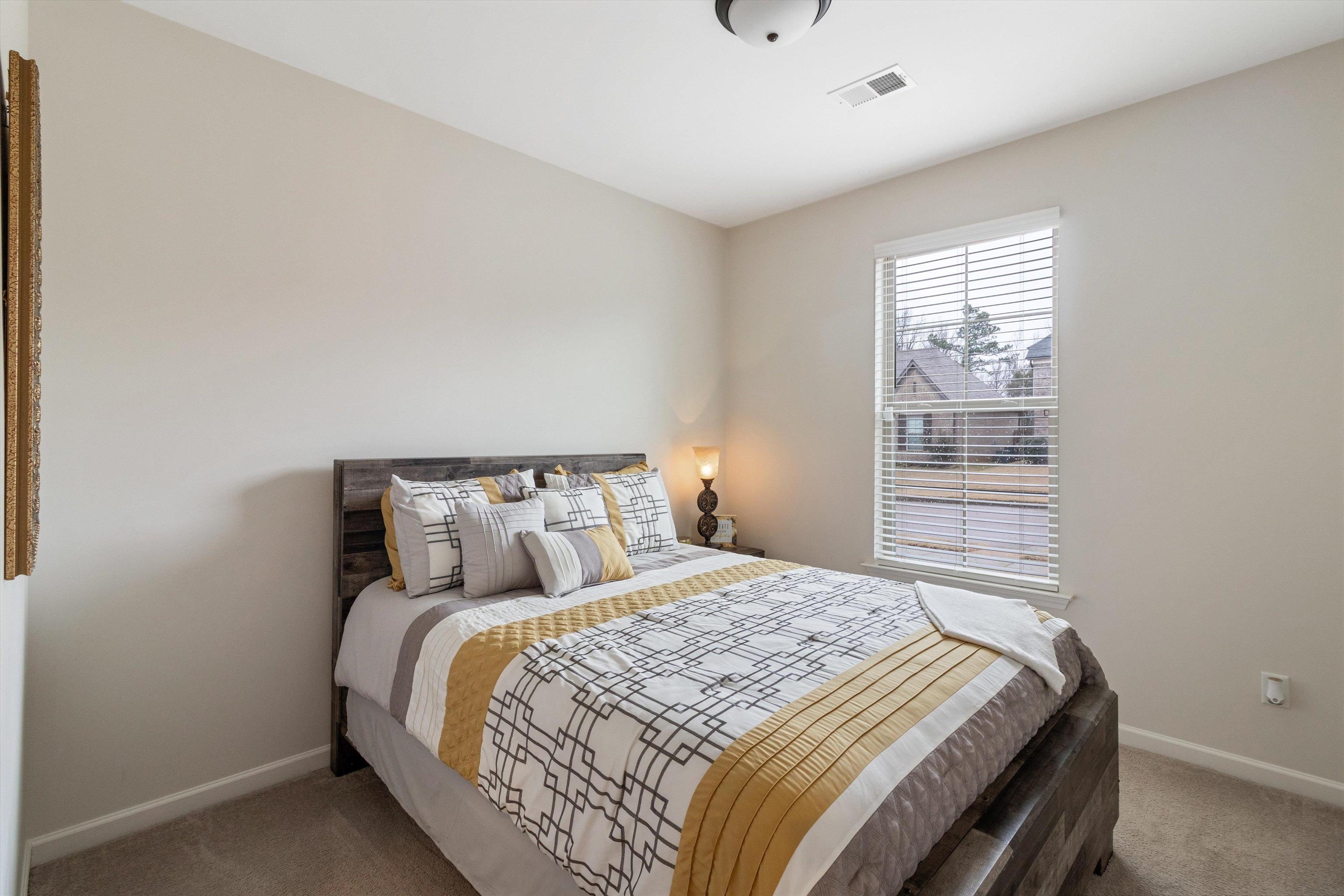 5504 Stonecrest Drive Olive Branch, MS 38654 - Photo 9 of 19 a bed sitting in a bedroom next to a window