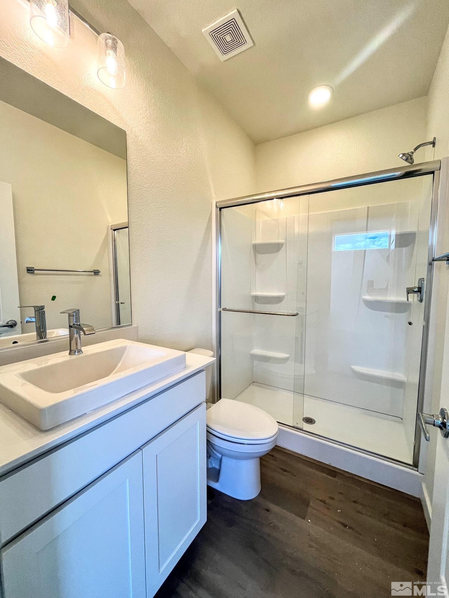 156 Rissone Lane, Unit LOT 33 Reno, NV 89503 - Photo 13 of 21 a bathroom with a sink toilet a mirror and shower