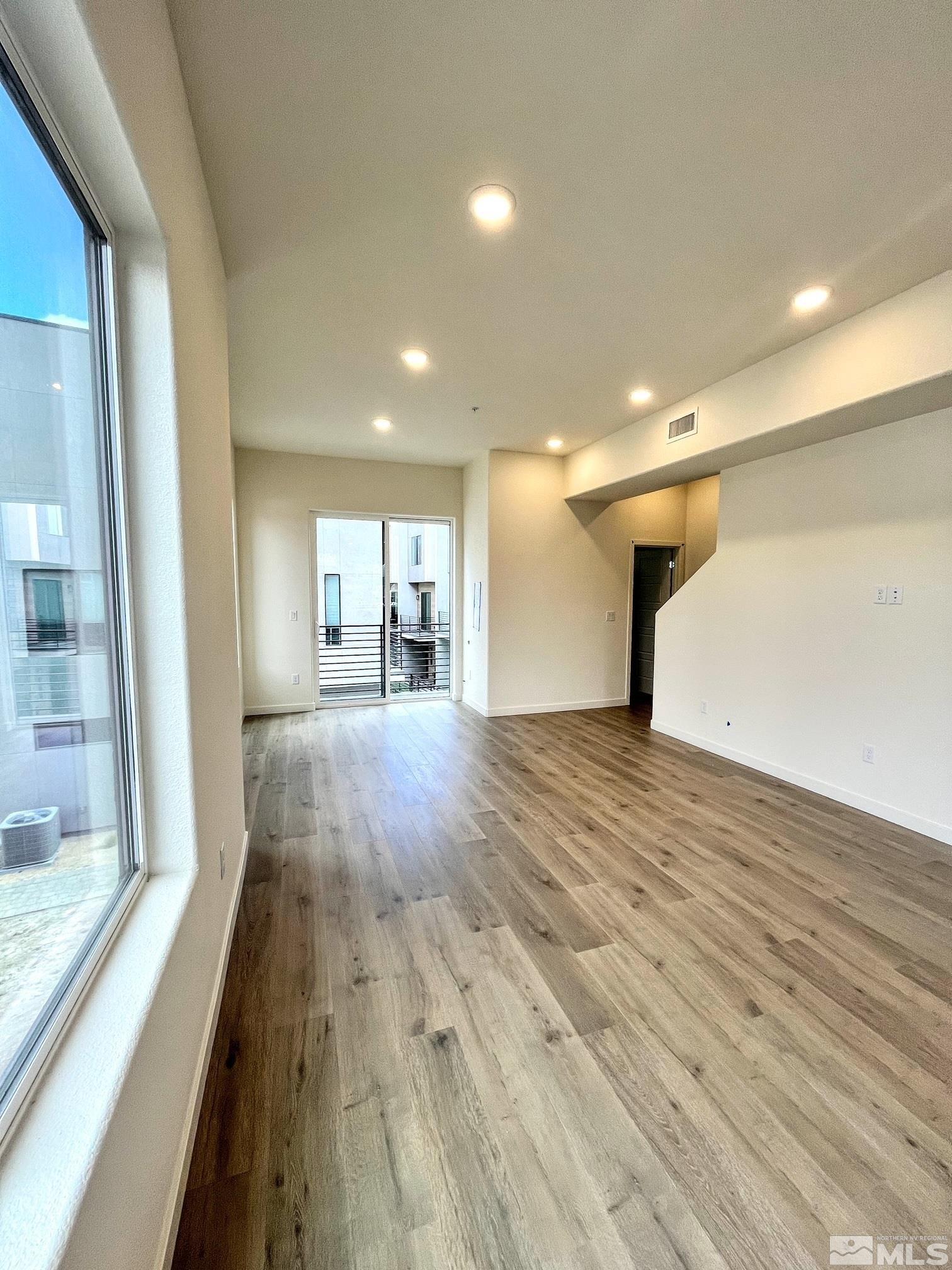 156 Rissone Lane, Unit LOT 33 Reno, NV 89503 - Photo 9 of 21 a view of a room with wooden floor and large windows
