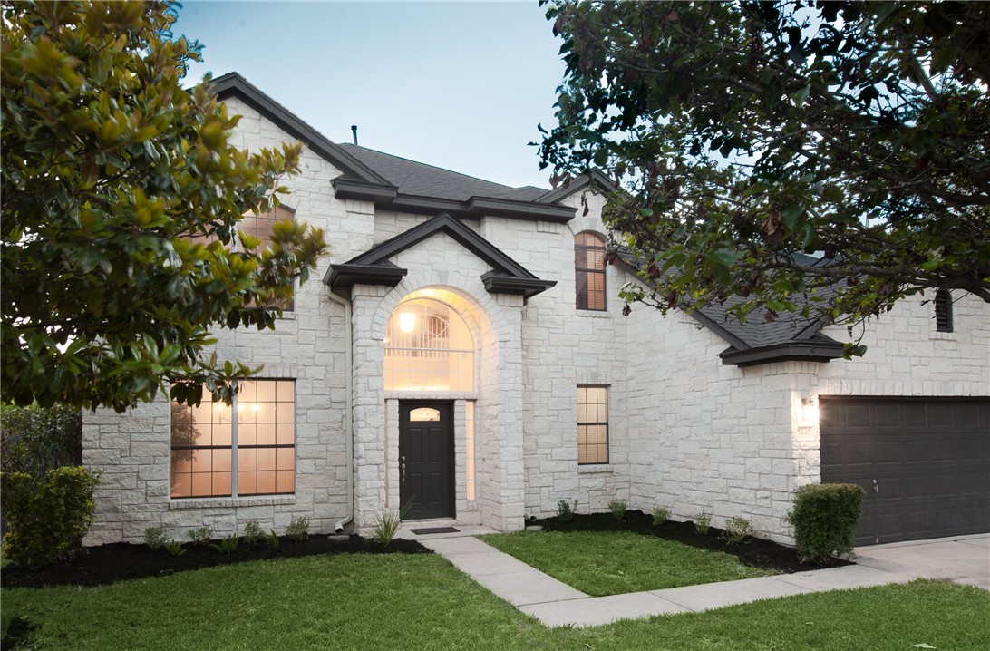 5440 Hitcher Bend Austin, TX 78749 - Photo 1 of 1 a front view of a house with a yard and garage