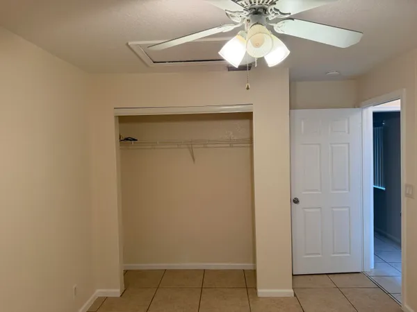 a view of a hallway with wooden floor and closet