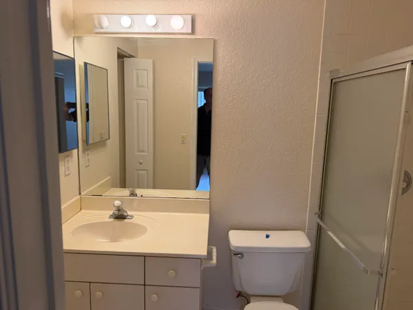 a white toilet sitting next to a bath tub