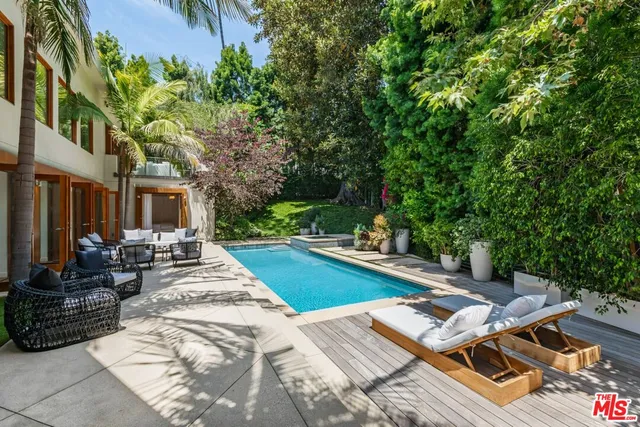 a view of a house with swimming pool and sitting area