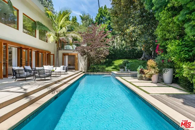 a swimming pool with outdoor seating and yard