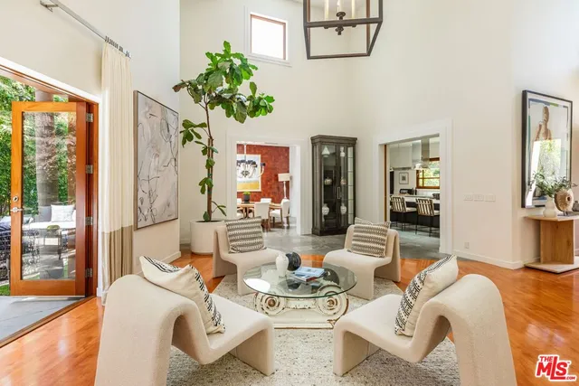 a living room with furniture a couch and a potted plant