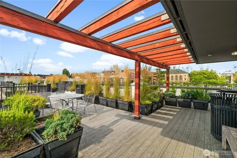 a view of a balcony with chairs and wooden floor