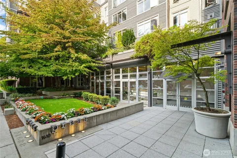 a view of a chair and table in backyard of the house