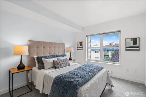 a bedroom with a bed and a lamp