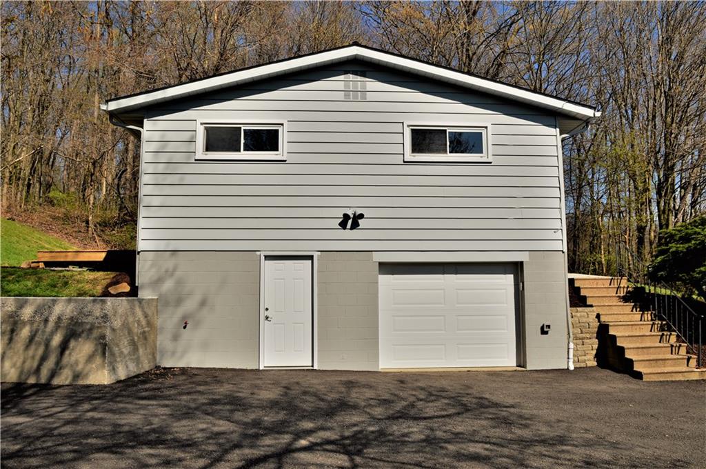 413 McCalmont Road Renfrew, PA 16053 - Photo 22 of 25 Side view of home. Garage door and man door to basement.
