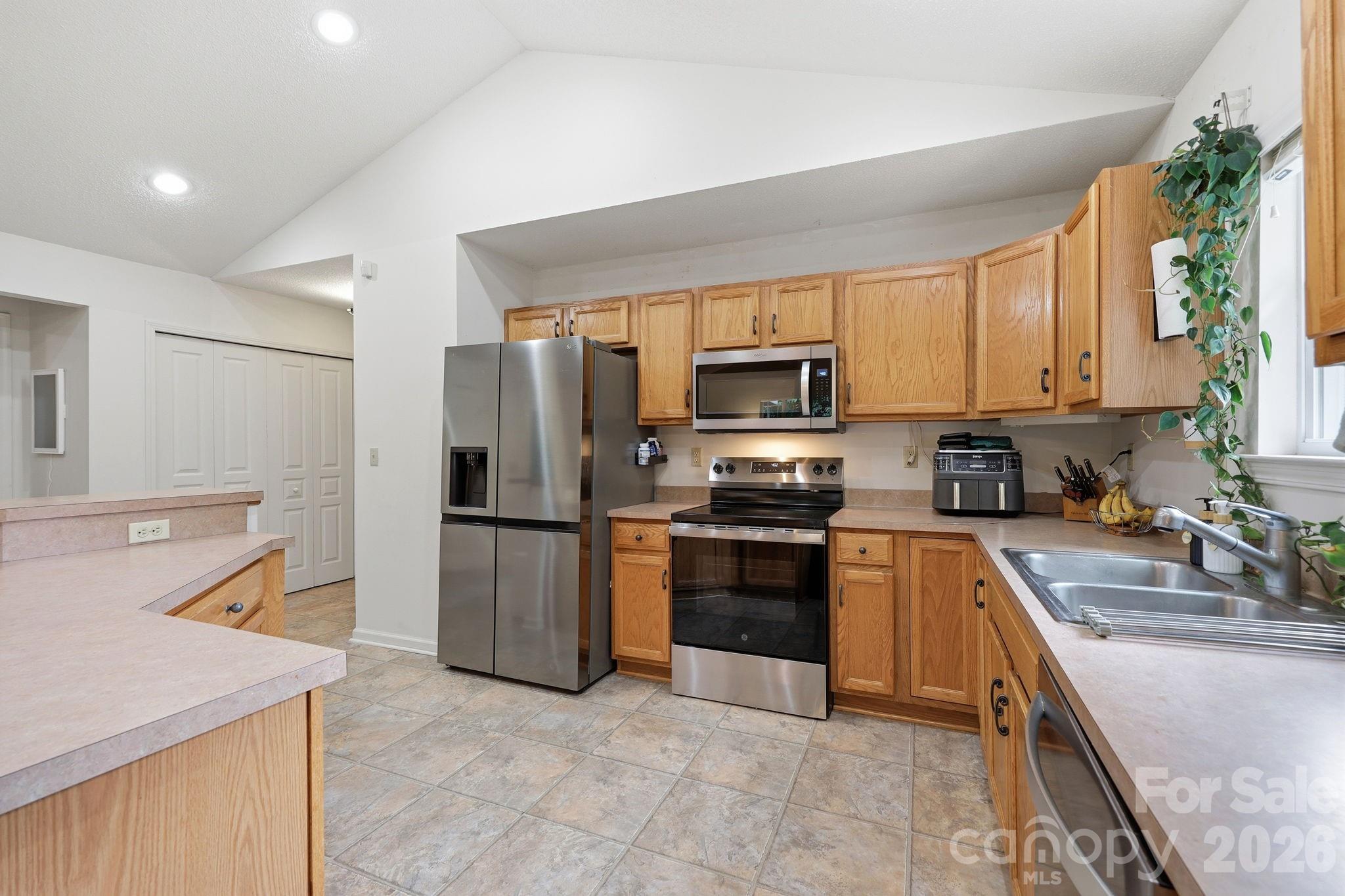 51 Sunview Circle Arden, NC 28704 - Photo 11 of 31 a kitchen with a sink a microwave a refrigerator and a stove top oven