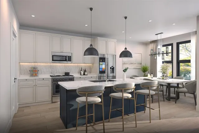 a kitchen with stainless steel appliances granite countertop a stove a sink a microwave a dining table and chairs