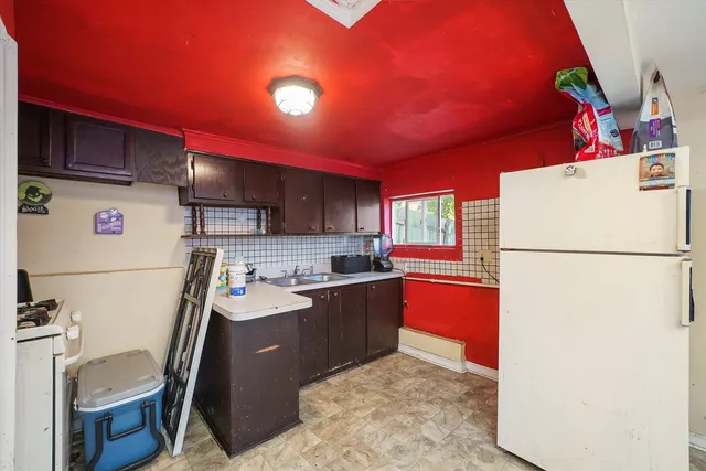 a kitchen with refrigerator and cabinets
