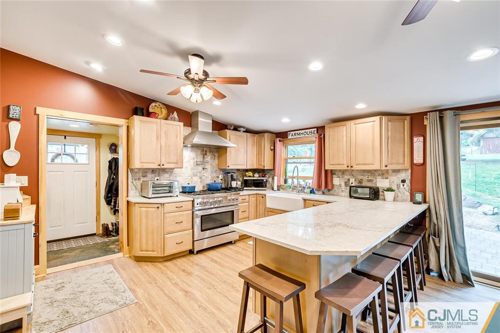 a kitchen with a stove a refrigerator and a dining table