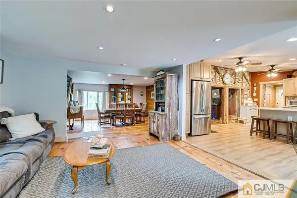 a living room with furniture and kitchen view