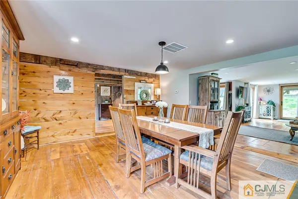 a dining room with furniture and wooden floor