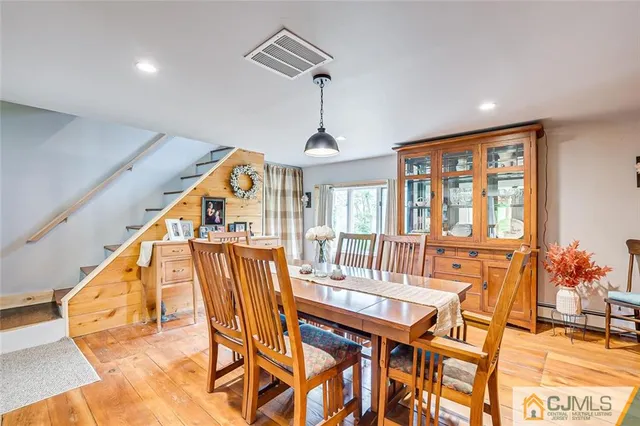 a dining room with furniture entryway and wooden floor