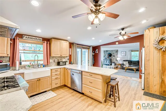 a large white kitchen with a large window