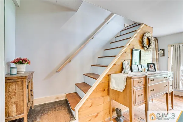 a view of an entryway with wooden floor and staircase