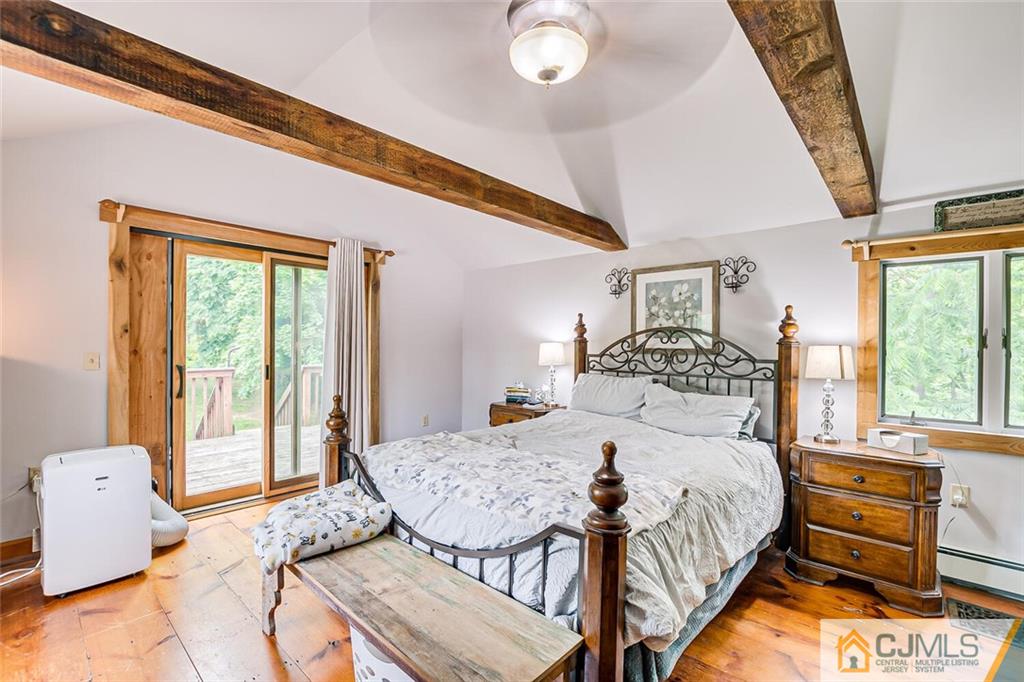 100 Mitchell Road Port Murray, NJ 07865 - Photo 27 of 48 a bedroom with a bed and wooden floor
