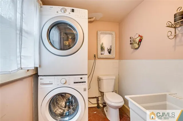 a white toilet sitting next to a bathroom sink and a tub