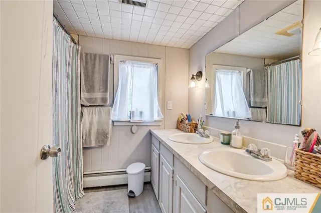 a bathroom with a sink a toilet and tub