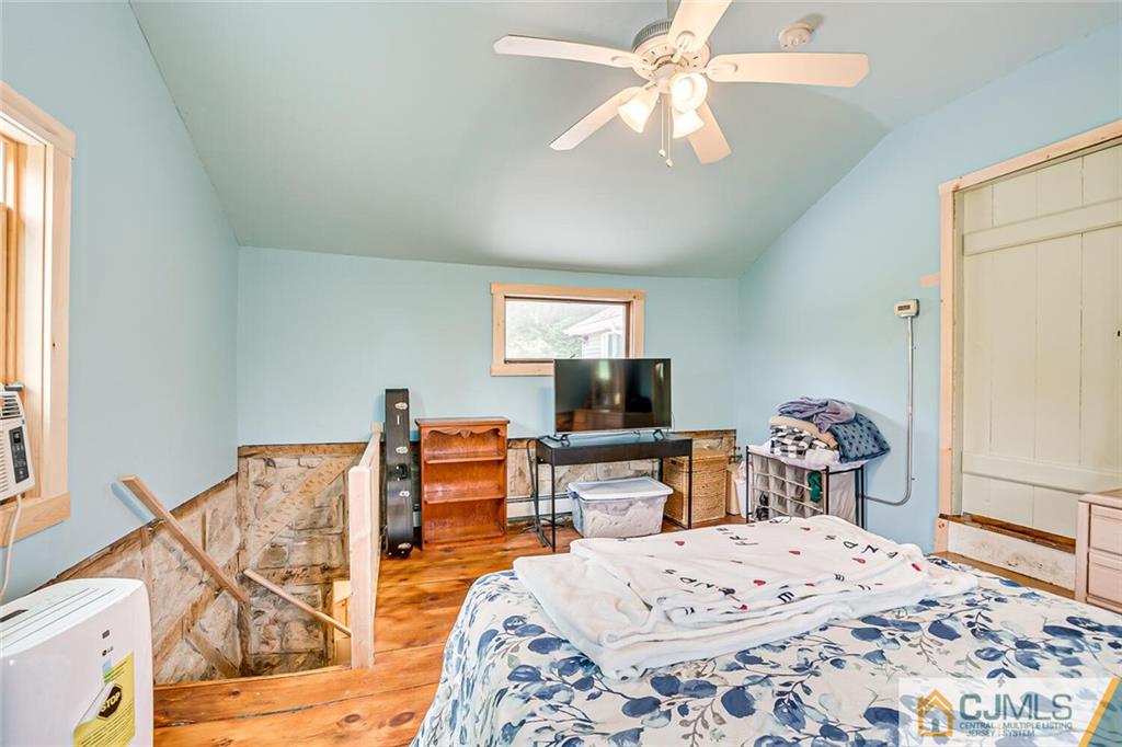 100 Mitchell Road Port Murray, NJ 07865 - Photo 33 of 48 a bedroom with a bed and a chandelier