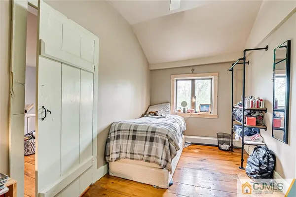 a bedroom with bed and a window