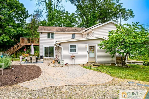a view of a house with backyard and sitting area