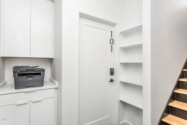 a kitchen with a refrigerator and a stove top oven