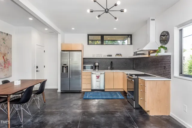 a kitchen with refrigerator and cabinets