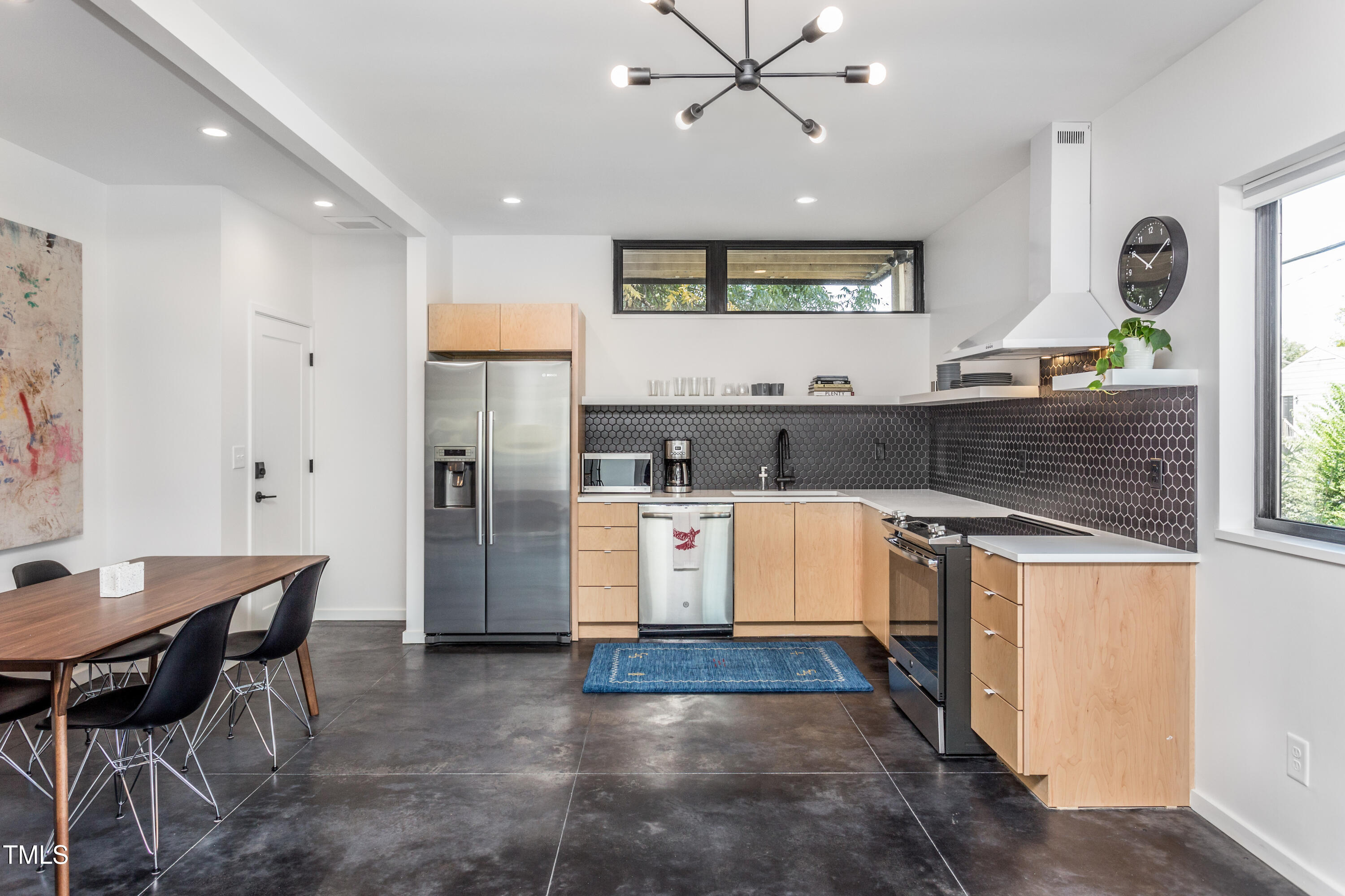 123 Idlewild Avenue, Unit 101 Raleigh, NC 27601 - Photo 12 of 27 a kitchen with refrigerator and cabinets