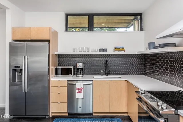a kitchen with a sink and a refrigerator