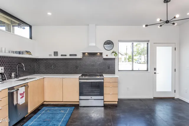a kitchen with granite countertop a stove and a sink