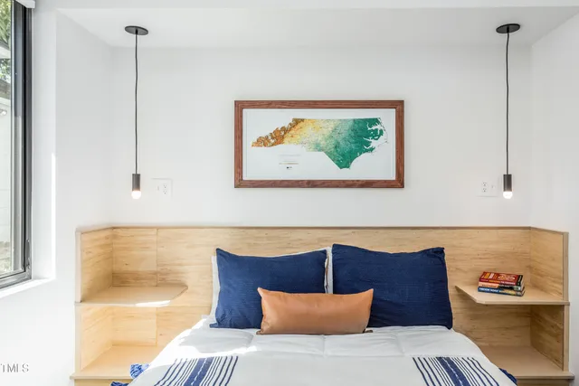a bedroom with a bed and wall painting