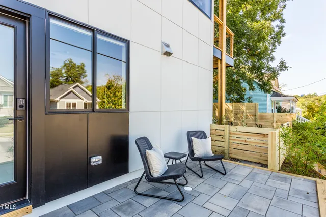 a view of two chairs in the balcony