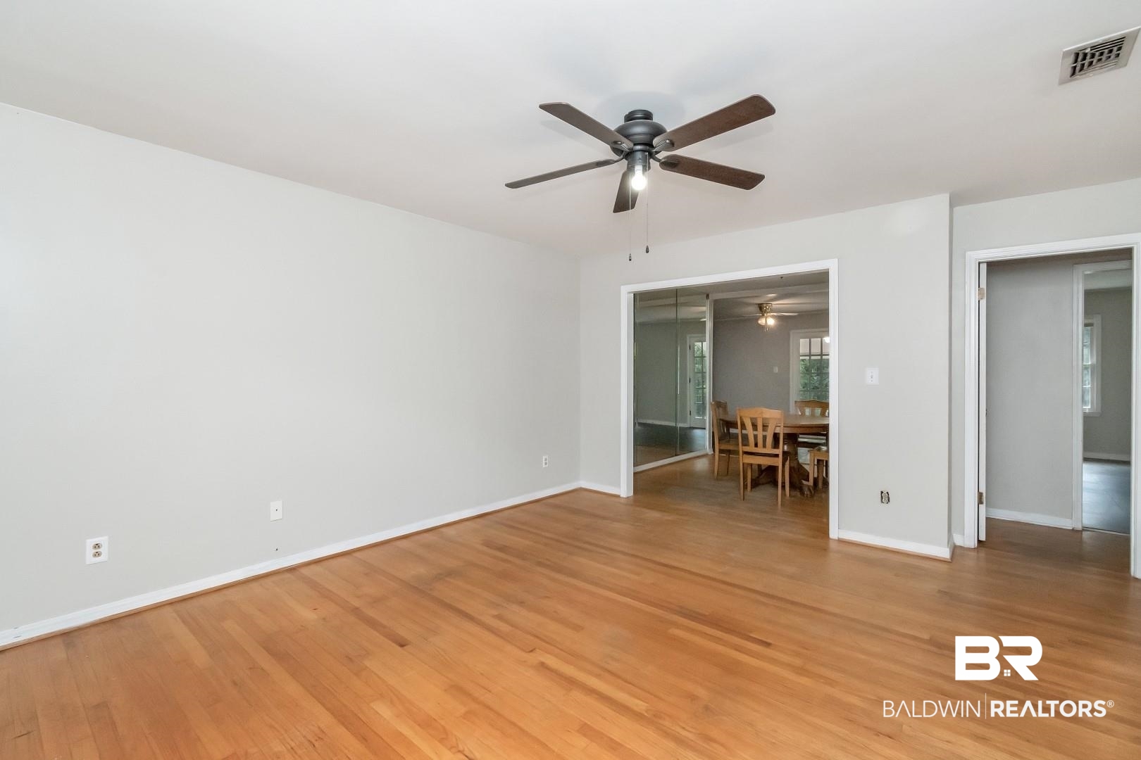 320 Vanderbilt Drive Mobile, AL 36608 - Photo 5 of 39 Unfurnished bedroom with ceiling fan, a closet, and hardwood / wood-style floors