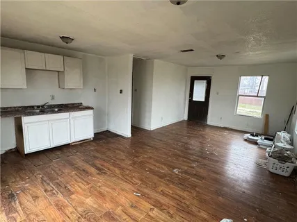 a kitchen with stainless steel appliances granite countertop a sink stove and wooden floor